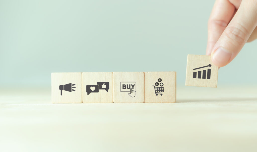 Growth of sales, marketing strategies concept. Data analytics for achieving business growth target. Increase sales in online store, e-commerce. Holding wooden cubes with sales growth. Postive progress